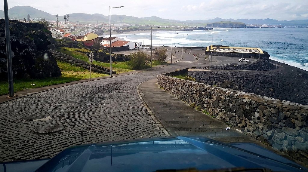 Cobbled coastal road and Atlantic coastline seen from the jeep, São Miguel